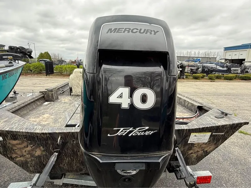 Slide: The Image of 2018 Lowe Roughneck 1760SC boat with Mercury 40 JetPower engine, parked outdoors. - 9
