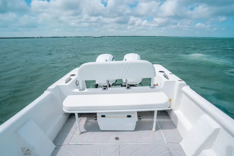 Slide: The Image of 2022 Panga Eduardoño Corvina boat on open water, featuring a spacious seating area. - 11