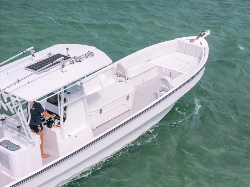 Slide: The Image of 2022 Panga Eduardoño Corvina boat on clear green water, viewed from above. - 5