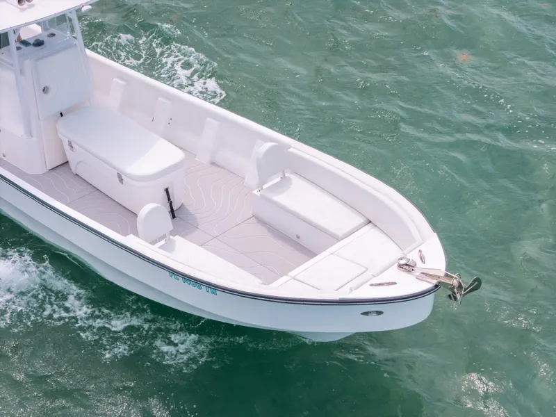 Slide: The Image of 2022 Panga Eduardoño Corvina boat on water, white hull, spacious deck, sleek design. - 6