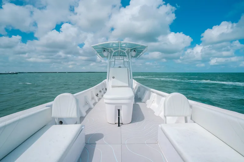 Slide: The Image of 2022 Panga Eduardoño Corvina boat on open sea under blue sky and clouds. - 7