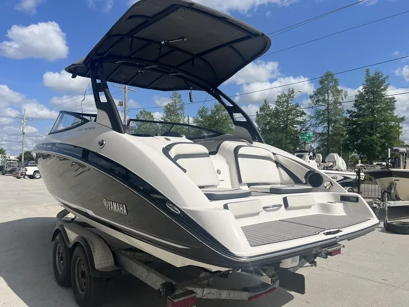 Slide: The Image of 2018 Yamaha Boats 242 Limited S E-Series on trailer, under clear blue sky. - 5