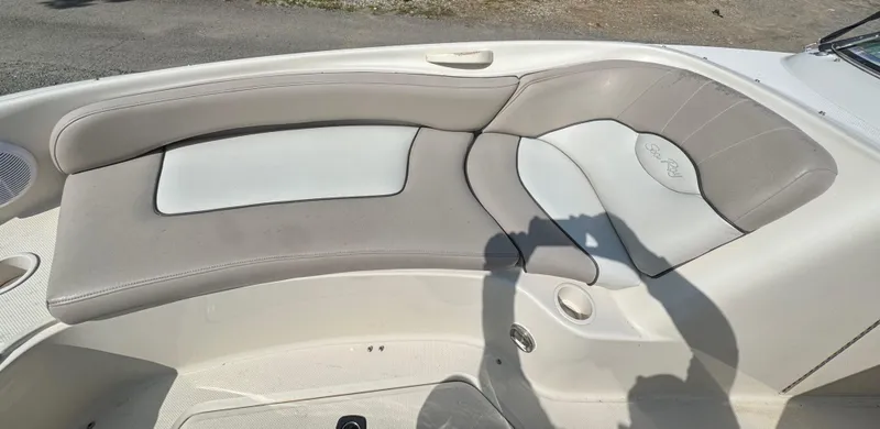 Slide: The Image of 2003 Sea Ray 240 Sundeck interior seating with gray and white upholstery. - 13