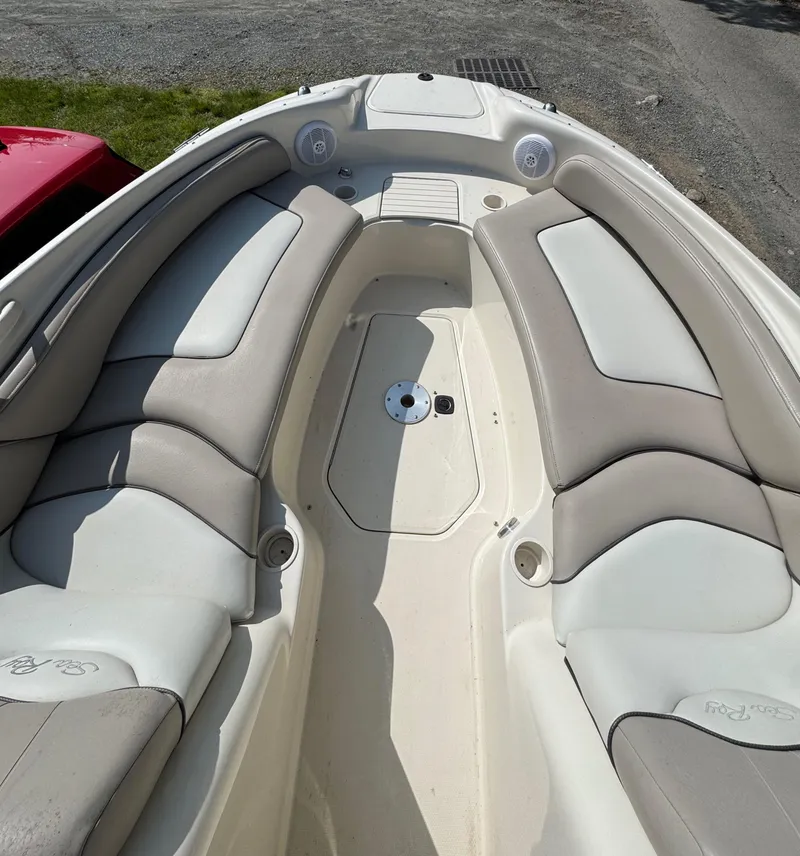 Slide: The Image of 2003 Sea Ray 240 Sundeck boat interior with cushioned seating and speakers. - 15