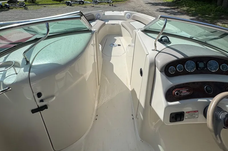 Slide: The Image of 2003 Sea Ray 240 Sundeck interior with dashboard and seating area. - 2