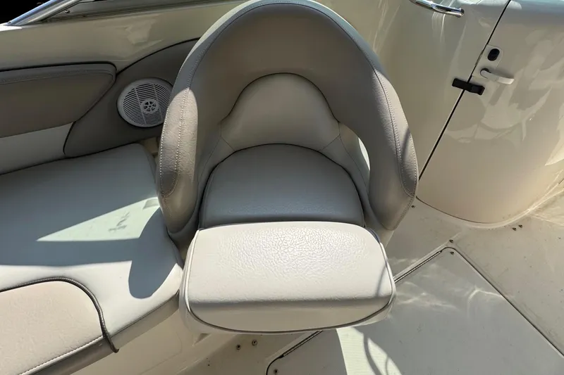 Slide: The Image of 2003 Sea Ray 240 Sundeck boat seat with speaker and door in view. - 8