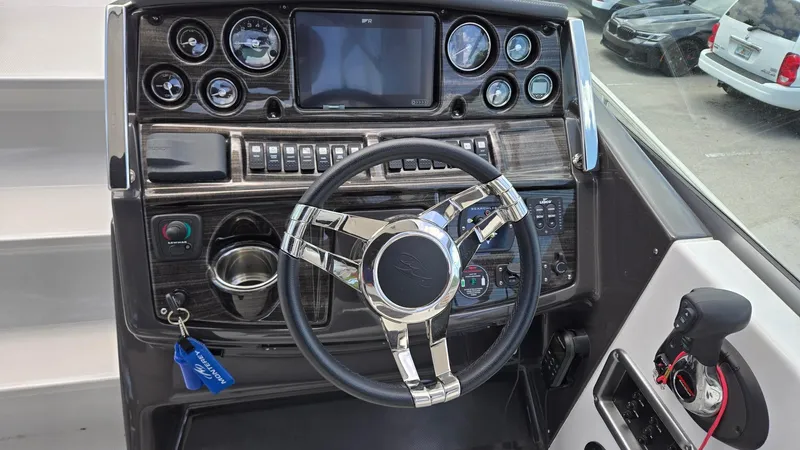 Slide: The Image of 2022 Monterey 295SY boat dashboard with steering wheel and control panel. - 10