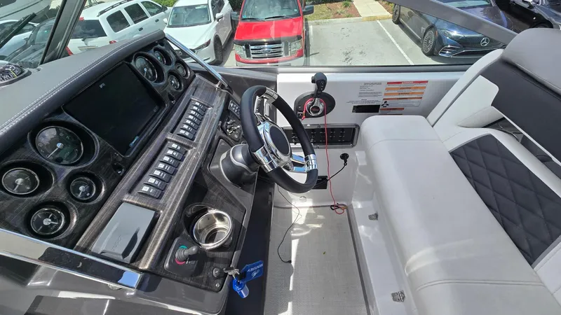Slide: The Image of Cockpit of 2022 Monterey 295SY boat with modern controls and steering wheel. - 11