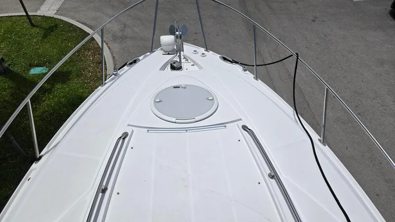 Slide: The Image of 2022 Monterey 295SY boat deck with railing, docked on pavement. - 12