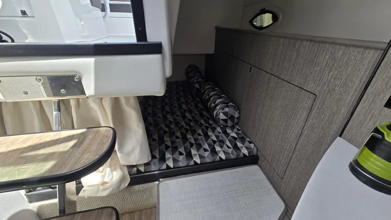 Slide: The Image of 2022 Monterey 295SY cabin interior with geometric-patterned bedding and modern furnishings. - 17