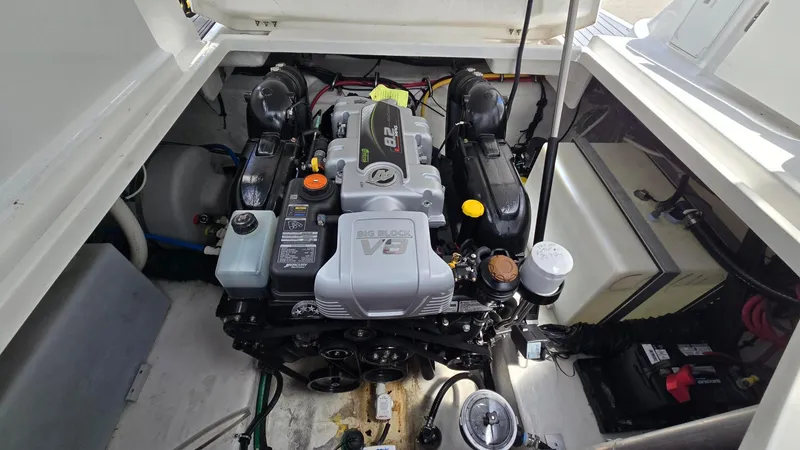 Slide: The Image of Engine compartment of 2022 Monterey 295SY boat, featuring a powerful V8 engine. - 19