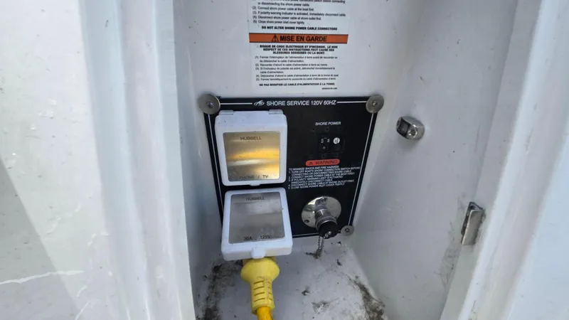 Slide: The Image of Electrical panel of 2022 Monterey 295SY boat with shore power connection. - 6
