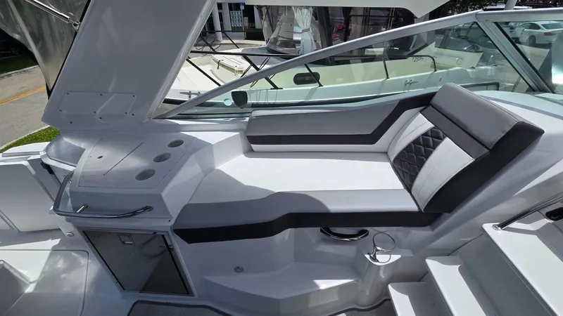 Slide: The Image of 2022 Monterey 295SY boat interior with sleek seating and modern design. - 9