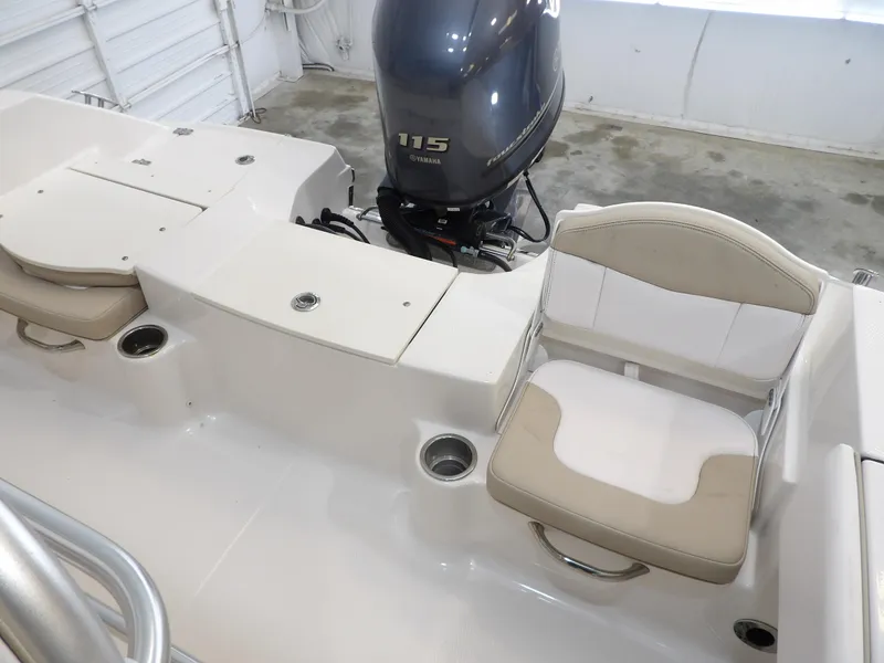 Slide: The Image of 2020 Robalo R180 boat interior with Yamaha 115 engine, featuring seating and storage. - 21