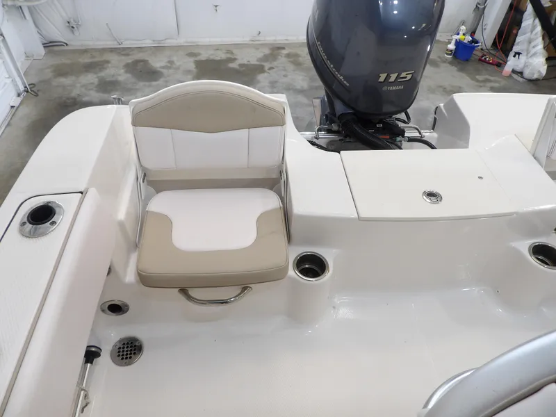 Slide: The Image of 2020 Robalo R180 boat interior with Yamaha 115 engine, featuring seating and cup holders. - 23
