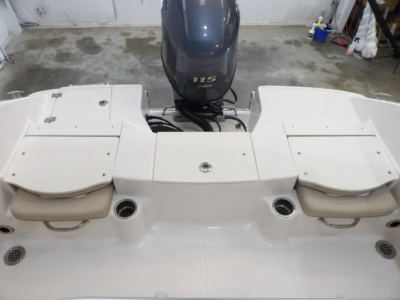 Slide: The Image of 2020 Robalo R180 boat with Yamaha 115 engine, featuring rear seating and storage compartments. - 24