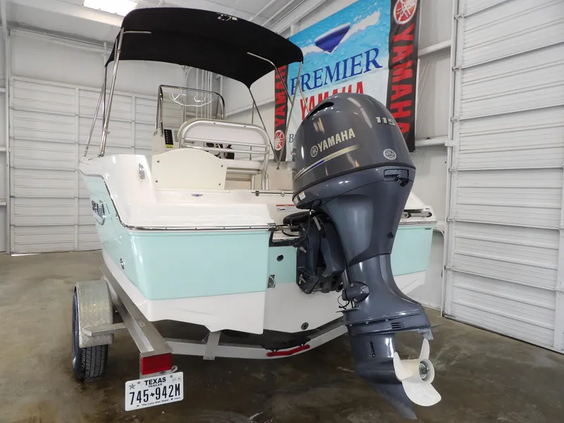 Slide: The Image of 2020 Robalo R180 boat with Yamaha outboard motor in a showroom. - 6