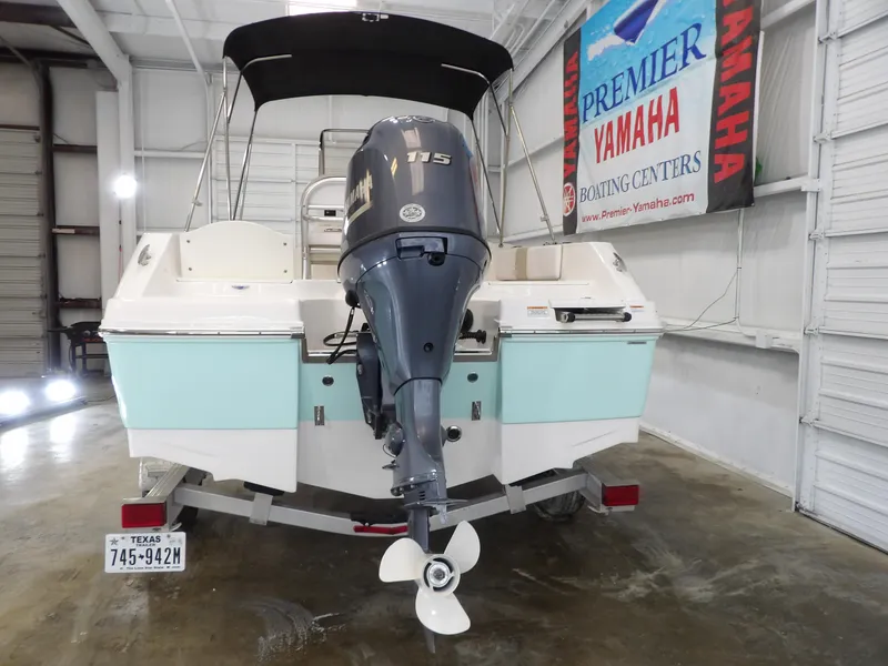Slide: The Image of 2020 Robalo R180 boat with Yamaha outboard motor in a showroom. - 7