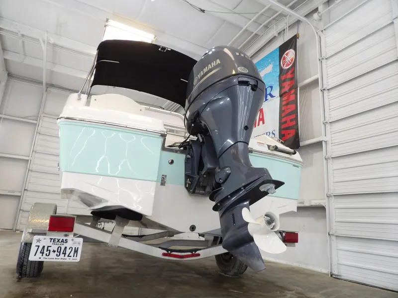 Slide: The Image of 2020 Robalo R180 boat with Yamaha outboard motor on trailer in garage. - 8