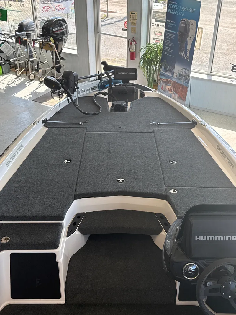 Slide: The Image of 2025 Skeeter ZXR20SE boat interior with Humminbird electronics and carpeted deck. - 18
