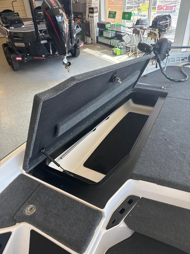 Slide: The Image of 2025 Skeeter ZXR20SE boat storage compartment open in showroom. - 20