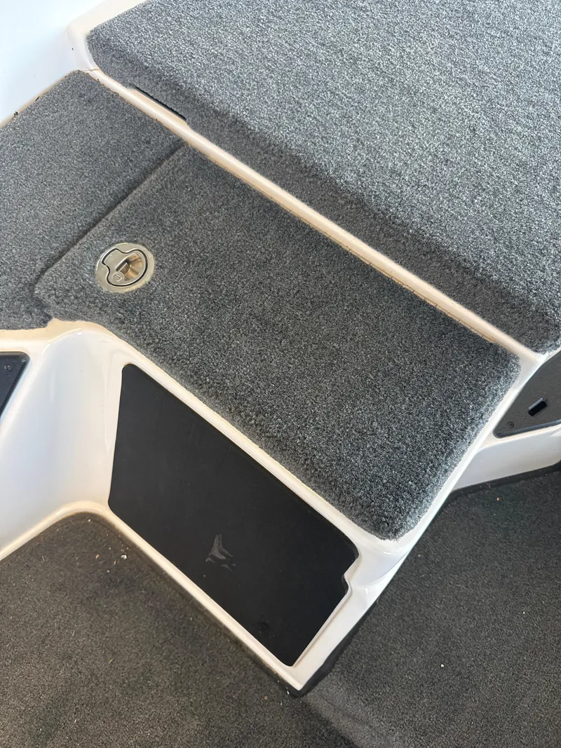 Slide: The Image of Carpeted deck of 2025 Skeeter ZXR20SE boat with storage compartment. - 22