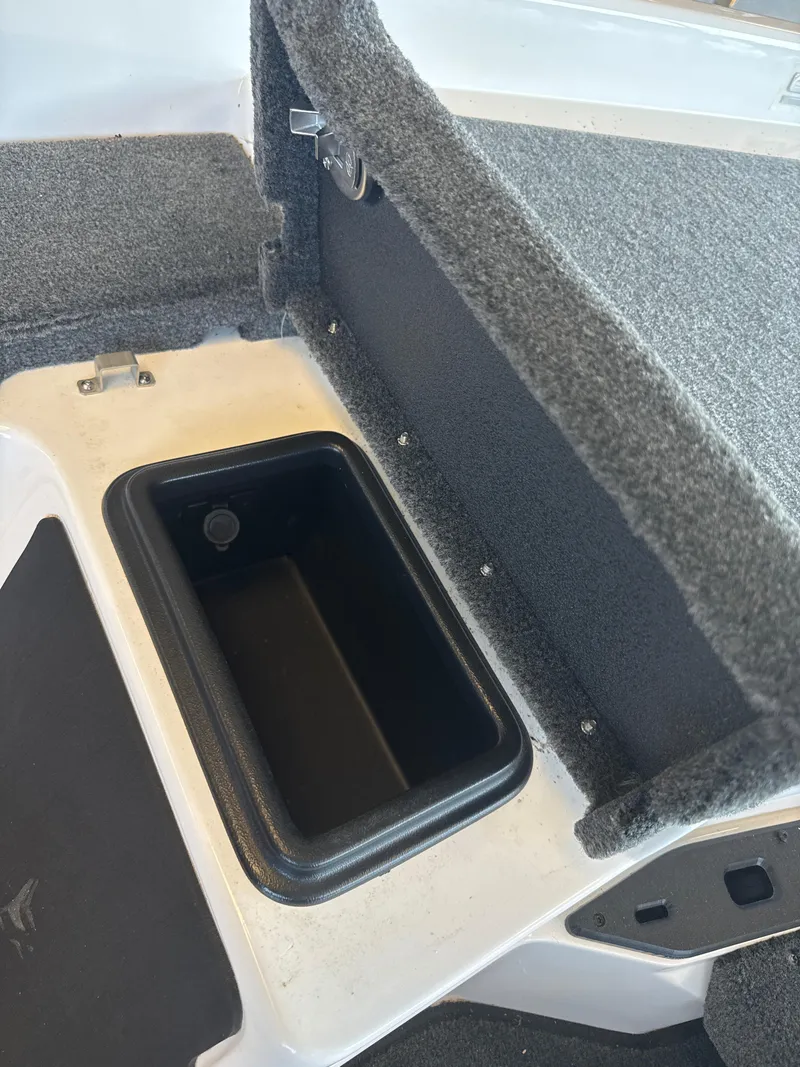 Slide: The Image of 2025 Skeeter ZXR20SE boat storage compartment with carpeted interior. - 23