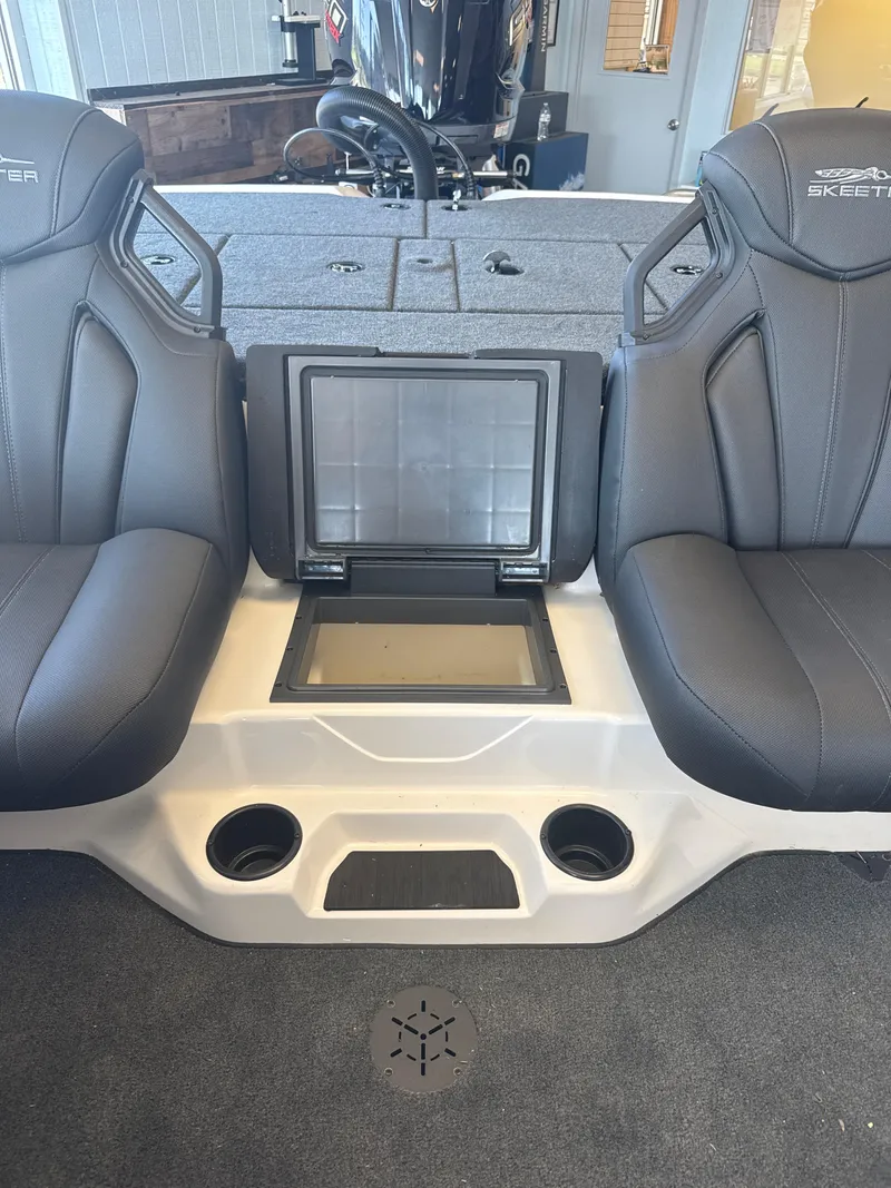 Slide: The Image of 2025 Skeeter ZXR20SE boat interior with two black seats and storage compartment. - 24
