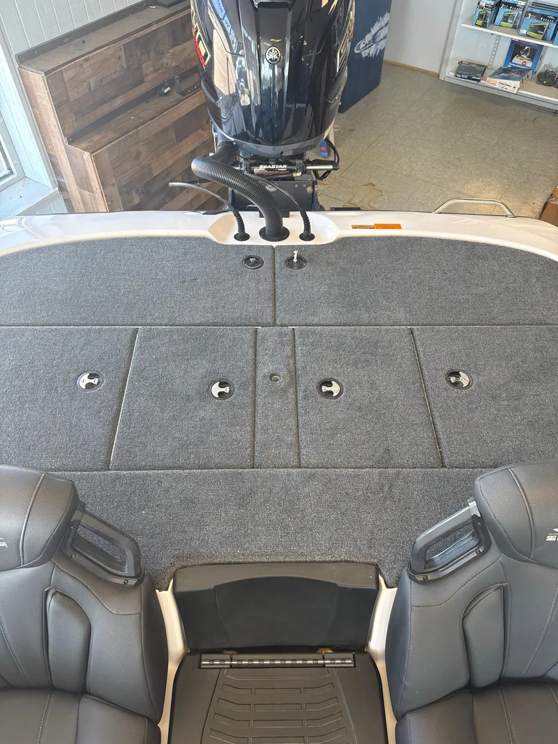 Slide: The Image of 2025 Skeeter ZXR20SE boat interior with carpeted deck and dual seats. - 25