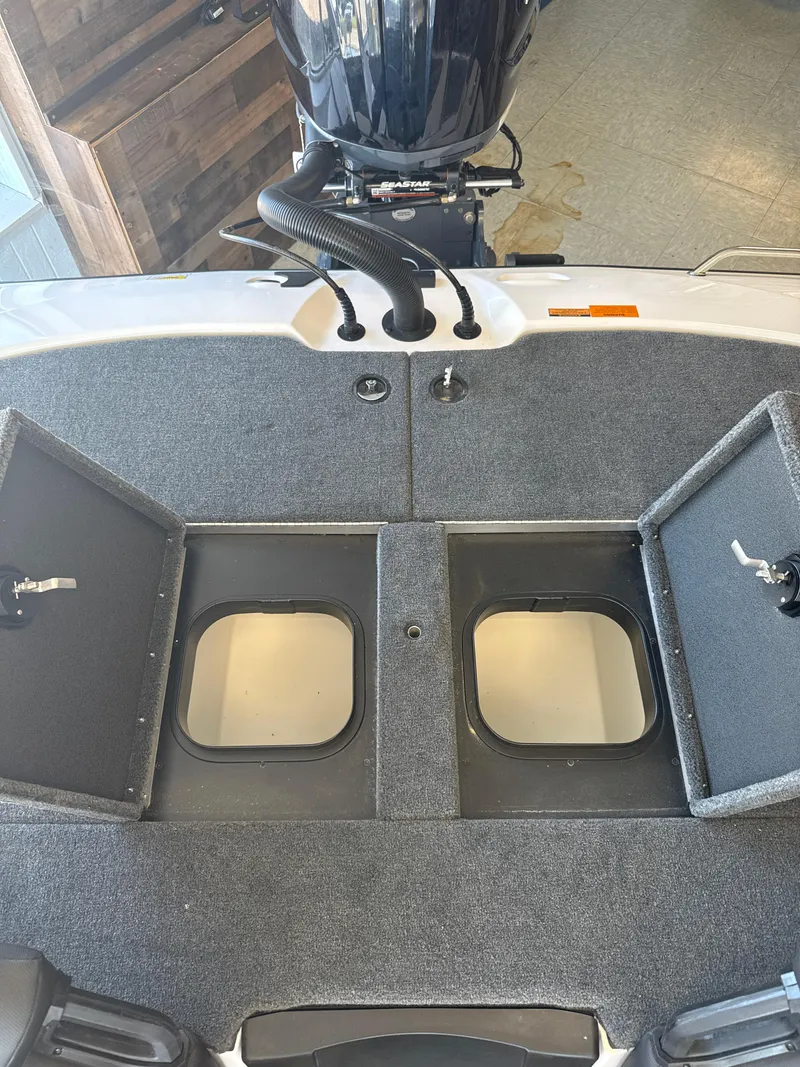 Slide: The Image of 2025 Skeeter ZXR20SE boat storage compartments with open hatches, showcasing interior space. - 26