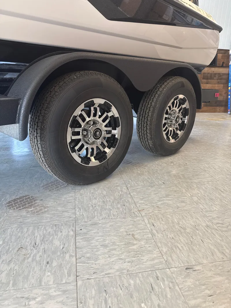Slide: The Image of 2025 Skeeter ZXR20SE trailer wheels on showroom floor. - 5