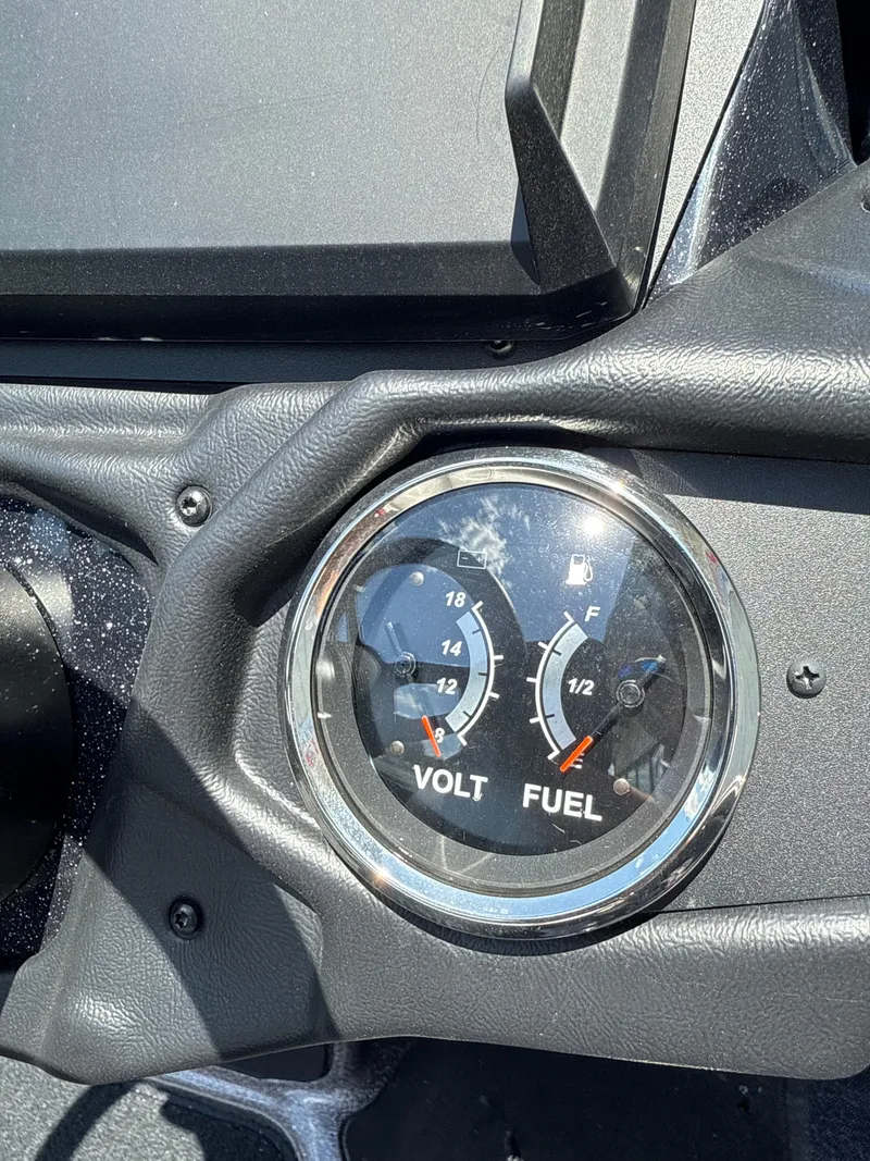 Slide: The Image of Dashboard gauges of 2025 Skeeter ZXR21SE showing voltage and fuel levels. - 14