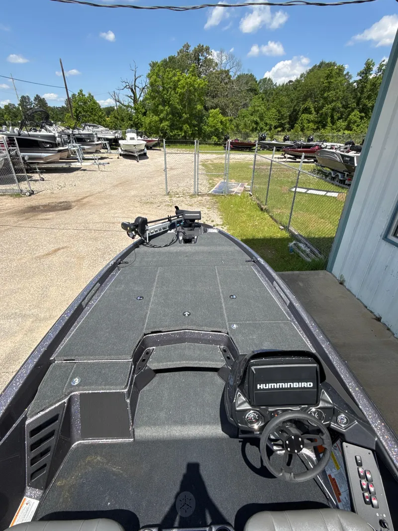 Slide: The Image of 2025 Skeeter ZXR21SE boat with Humminbird electronics, parked outdoors on a sunny day. - 21