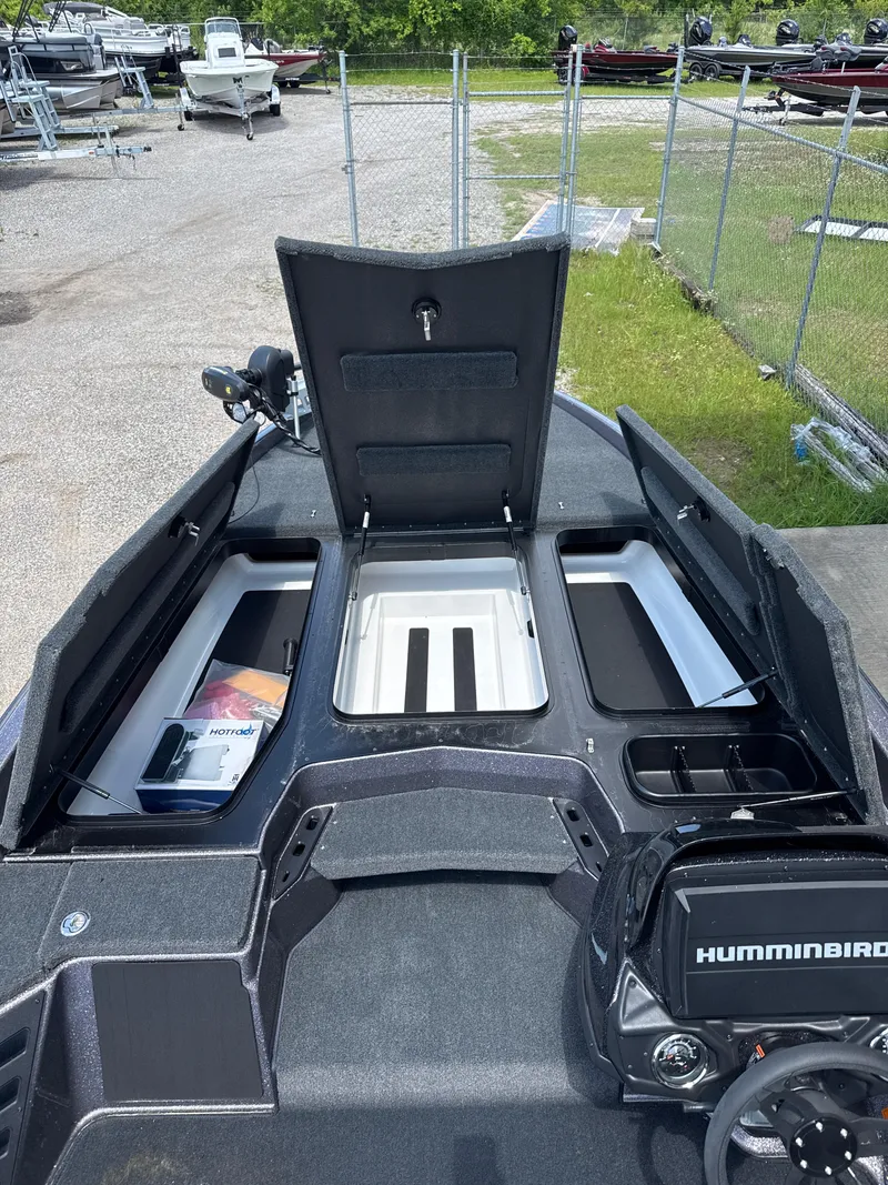 Slide: The Image of 2025 Skeeter ZXR21SE boat interior with open storage compartments and Humminbird electronics. - 22