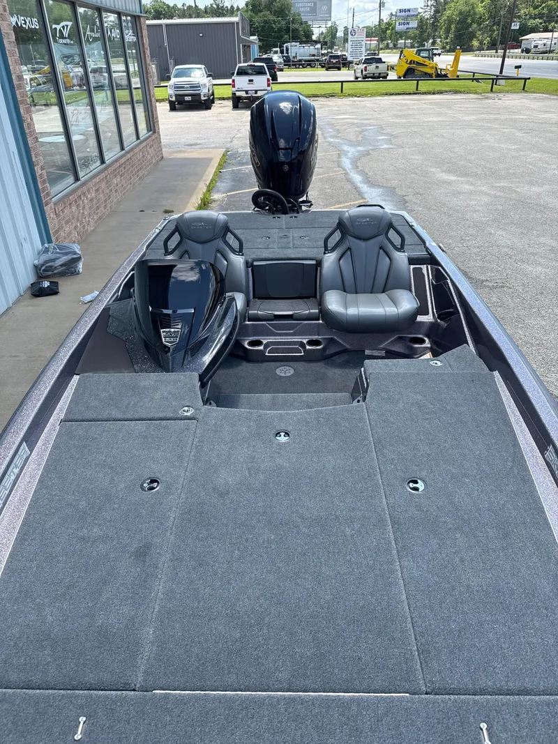 Slide: The Image of 2025 Skeeter ZXR21SE boat with sleek seating and powerful outboard motor. - 23