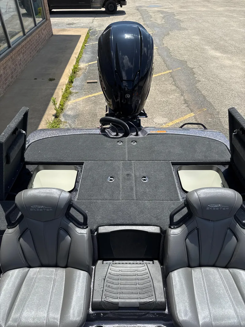 Slide: The Image of 2025 Skeeter ZXR21SE boat interior with dual seats and outboard motor. - 28