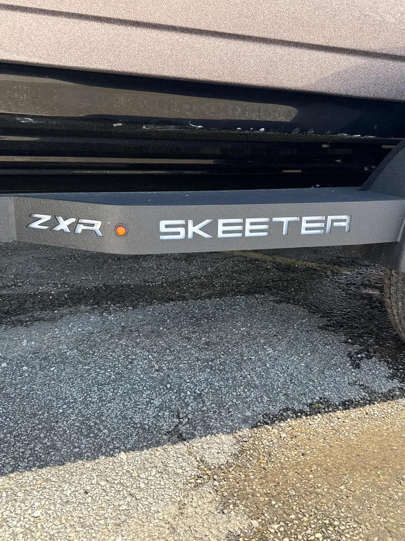 Slide: The Image of 2025 Skeeter ZXR21SE boat trailer on asphalt surface. - 5