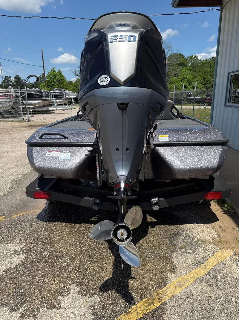 Slide: The Image of 2025 Skeeter ZXR21SE boat with powerful 250 engine, parked outdoors. - 8