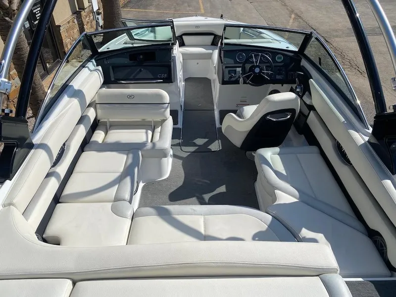 Slide: The Image of 2018 Cobalt CS23 Surf boat interior with white seating and modern dashboard. - 11