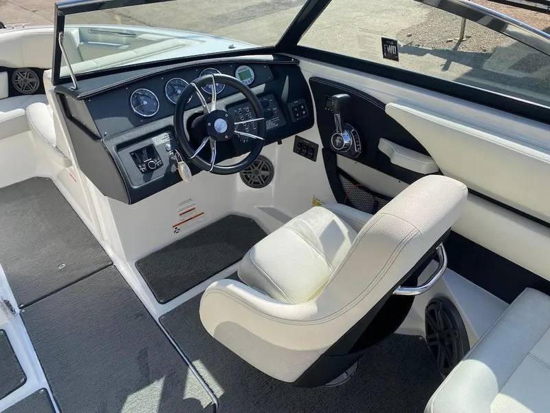 Slide: The Image of 2018 Cobalt CS23 Surf boat interior with steering wheel and dashboard controls. - 14