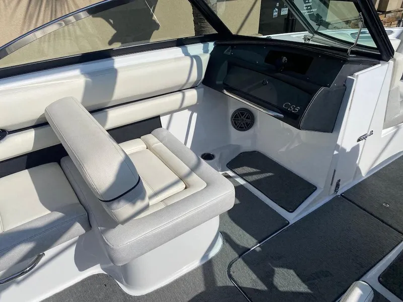Slide: The Image of 2018 Cobalt CS23 Surf boat interior with white seating and dashboard. - 17