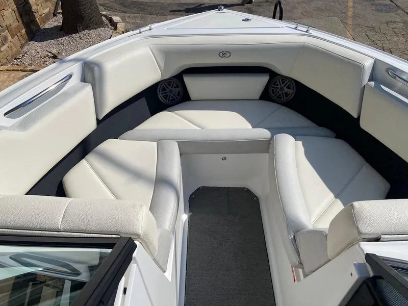 Slide: The Image of 2018 Cobalt CS23 Surf boat interior with white cushioned seating. - 18