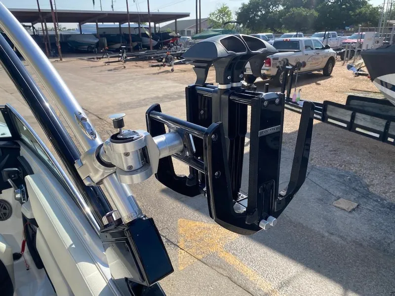 Slide: The Image of Wakeboard rack on a 2018 Cobalt CS23 Surf boat, parked in a marina. - 21