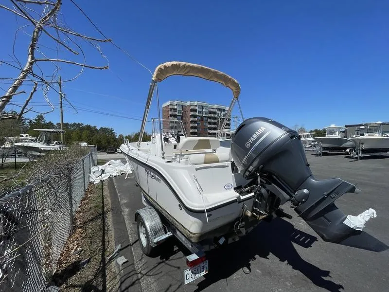 Slide: The Image of 2022 Edgewater 170CC boat with Yamaha outboard motor on a trailer, parked outdoors. - 7
