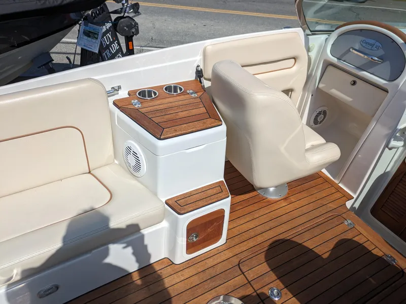 Slide: The Image of 2008 Chris-Craft Corsair 25 interior with beige seating and wooden accents. - 10