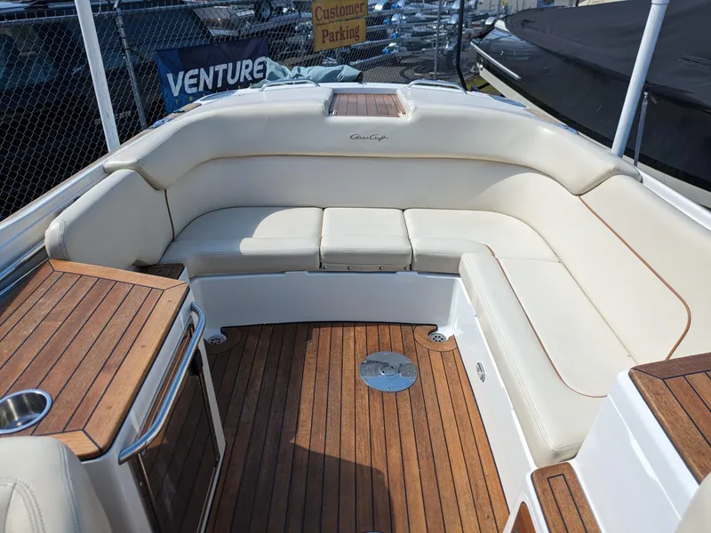 Slide: The Image of 2008 Chris-Craft Corsair 25 boat interior with teak flooring and cream seating. - 13