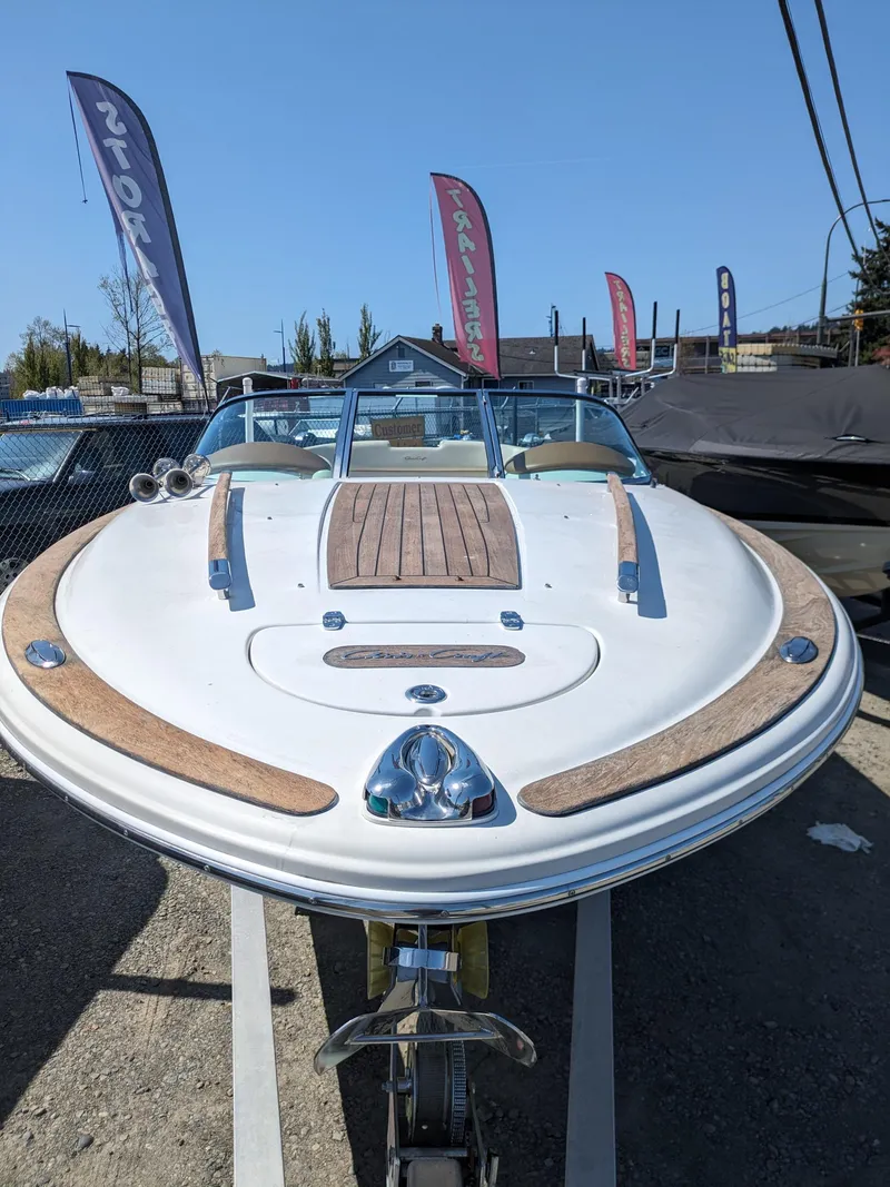 Slide: The Image of 2008 Chris-Craft Corsair 25 boat with sleek design and wooden deck accents. - 5