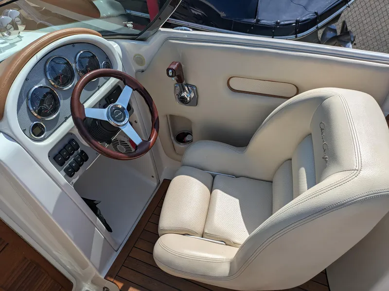 Slide: The Image of 2008 Chris-Craft Corsair 25 cockpit with leather seat and classic steering wheel. - 6