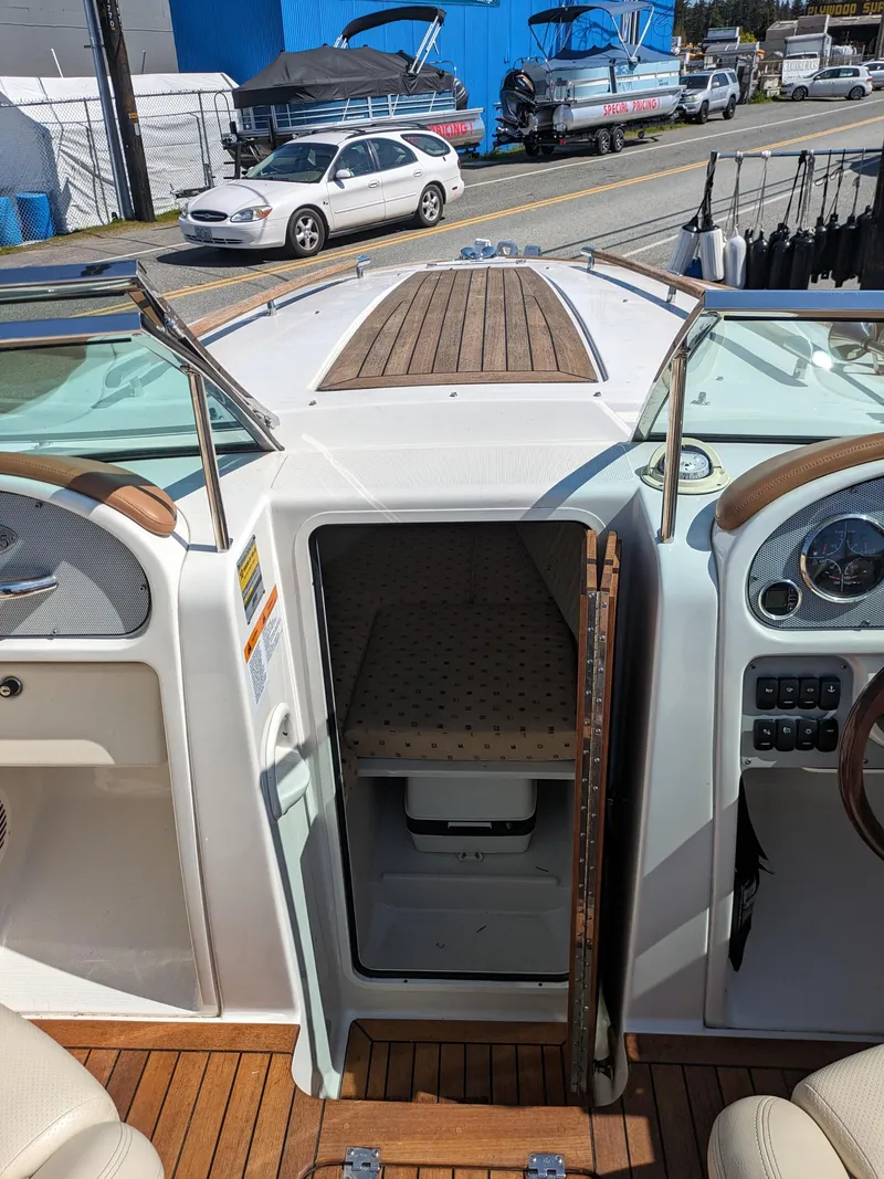 Slide: The Image of 2008 Chris-Craft Corsair 25 boat interior with wooden deck and cabin entrance. - 8