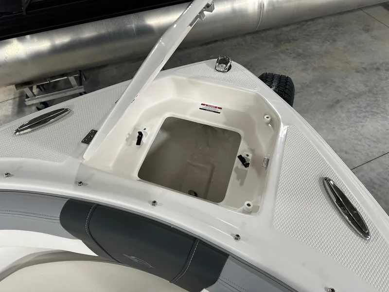 Slide: The Image of 2025 Chaparral 23 SSi boat with open storage compartment on deck. - 12